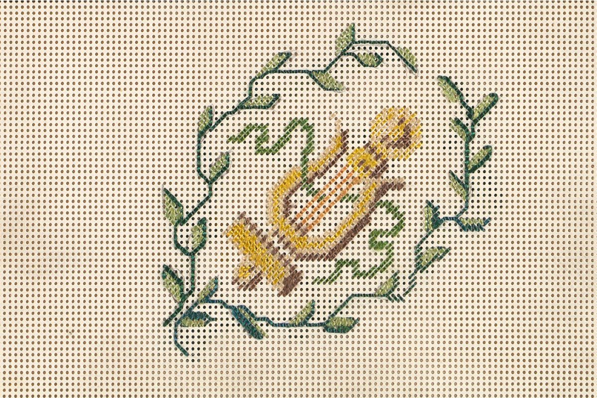 Embroidered design of an ancient Greek lyre surrounded by leafy vines on a perforated canvas background.