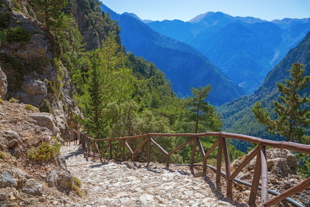 Hiking trail through Samaria Gorge in Crete, Greece – popular trekking route surrounded by mountains and pine forest