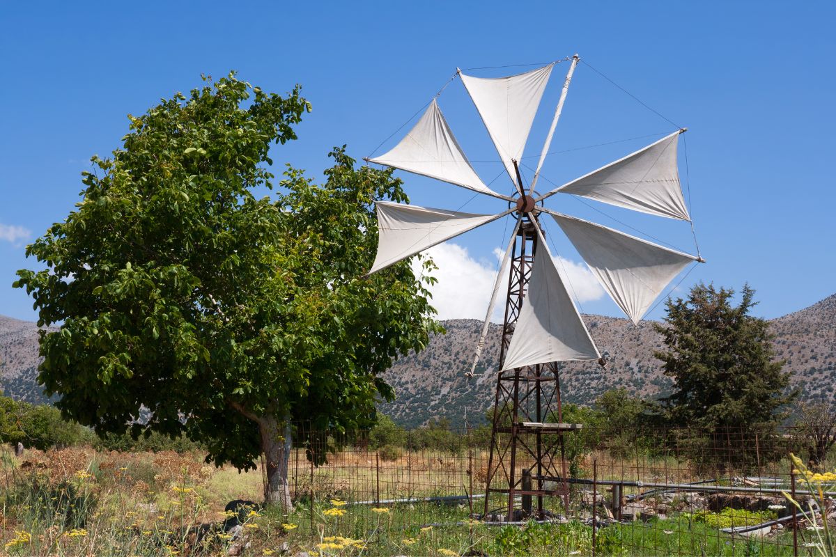 Traditional windmill with cloth sails in the Lasithi Plateau, Crete, Greece – rural landscape and agricultural heritage