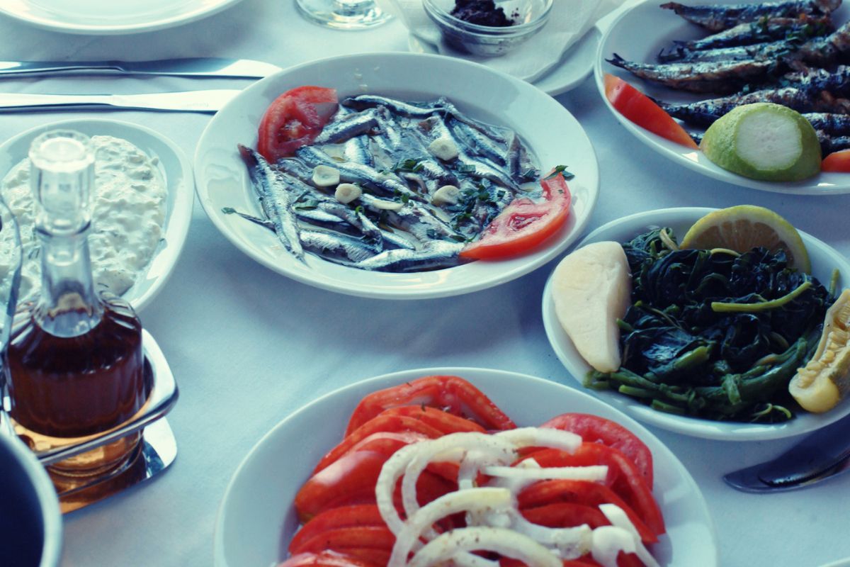 Traditional Cretan dishes served at a local taverna – featuring fresh seafood, boiled greens, tomato salad, and olive oil