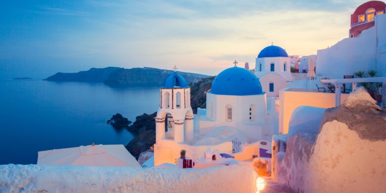 Blue-domed church in Santorini overlooking the Aegean Sea near Crete