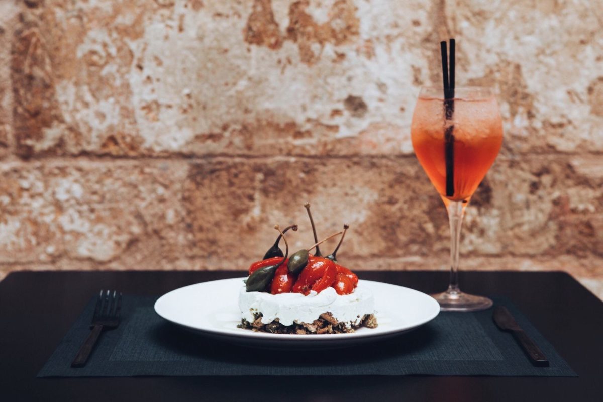 Ntakos / Barley rusk crumble, mizithra cream with aromatic herbs and honey, marinated cherry tomatoes and caper berries at Mon.Es Restaurant