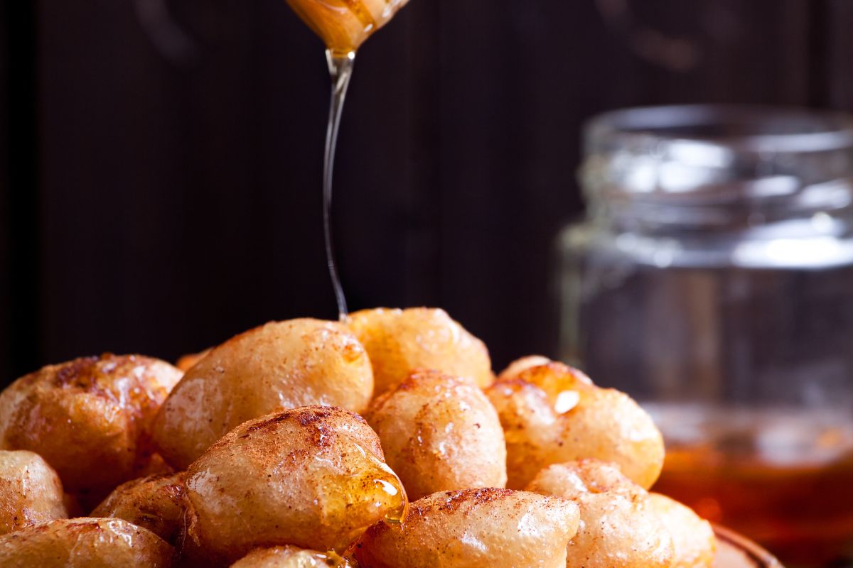 Traditional Cretan dessert loukoumades topped with honey, a popular sweet treat in Cretan cuisine
