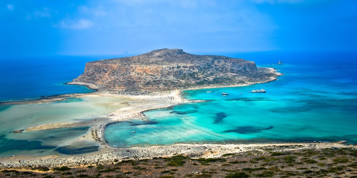 Balos Beach in Chania, Crete with turquoise waters, sandy shores, and a view of Gramvousa Island in the background