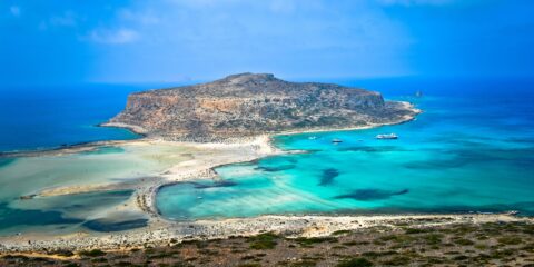 Balos Beach in Chania, Crete with turquoise waters, sandy shores, and a view of Gramvousa Island in the background