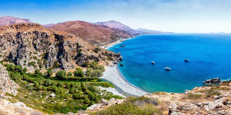 Preveli Beach in Crete with a palm forest and turquoise sea.