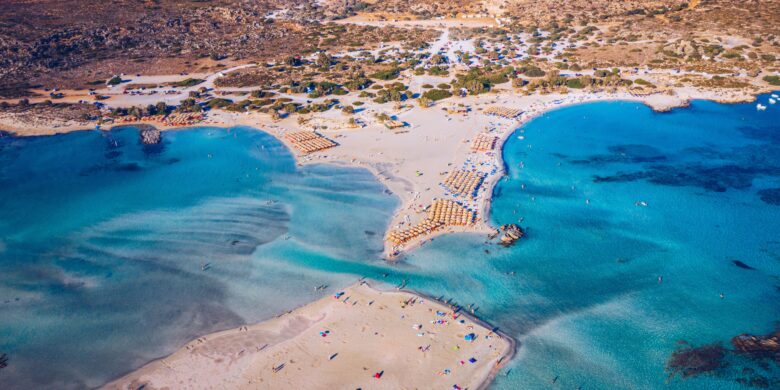 Aerial view of Elafonissi Beach in Crete with turquoise waters and sandy shores, a top Crete to do activity for beach lovers.