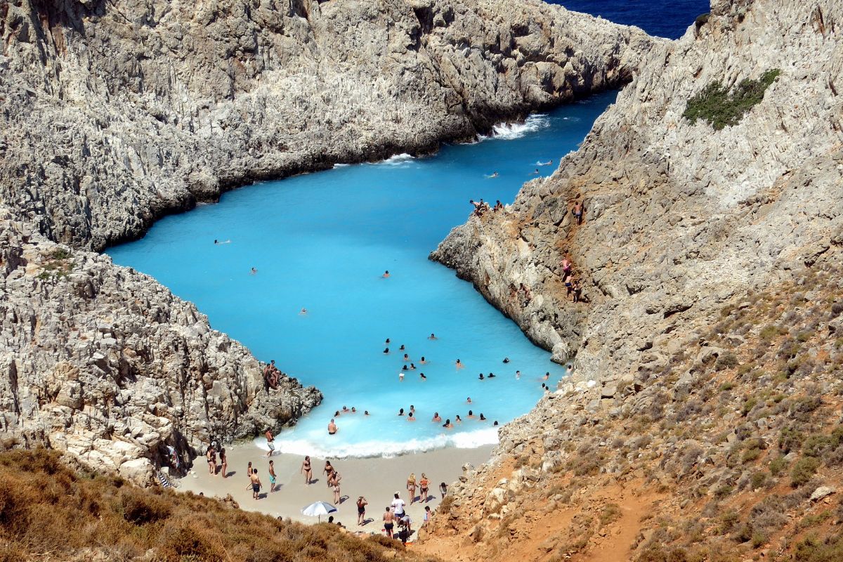 Seitan Limania beach Crete with visitors swimming and relaxing on the shore
