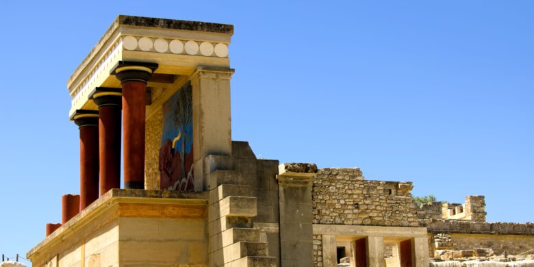 Colorful section of the ancient Knossos Palace in Heraklion Crete, featuring red Minoan columns and historic fresco, a must-see archaeological site in Crete Greece.