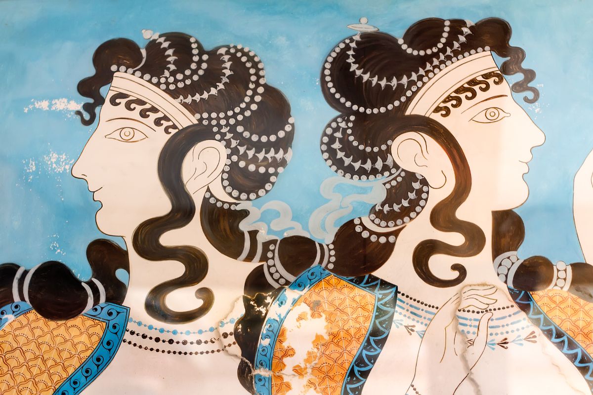 Minoan fresco from the Palace of Knossos in Crete, Greece, depicting elegant figures in ancient artistic style.