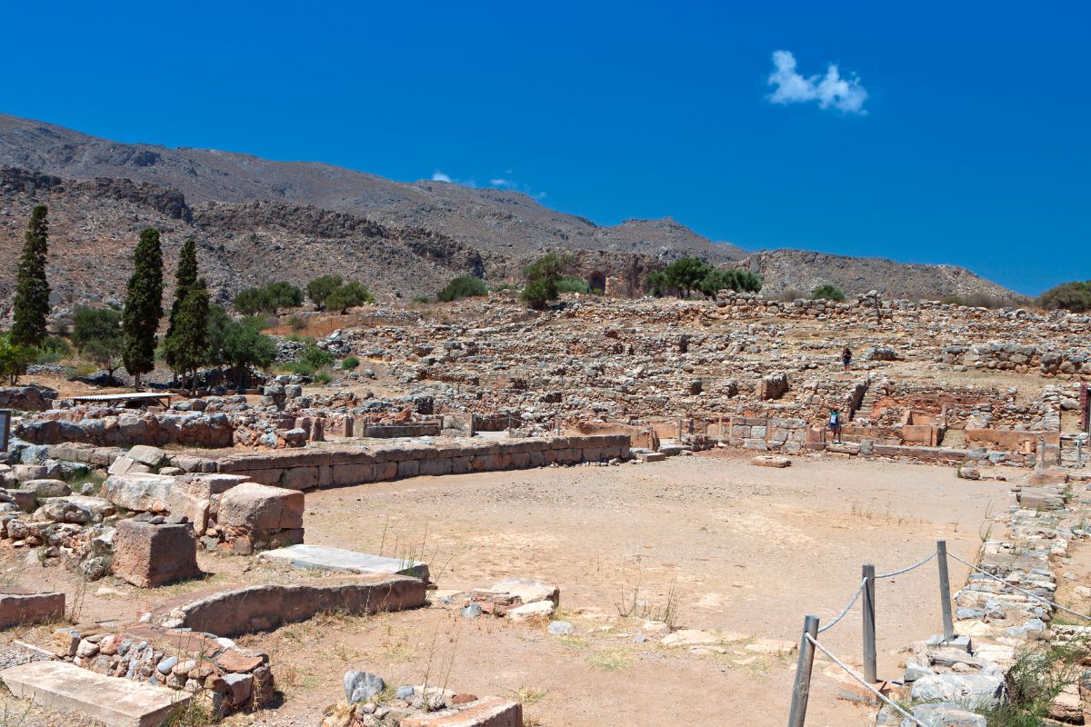 Archaeological site of Zakros Palace in eastern Crete, Greece, showcasing ancient Minoan ruins surrounded by rugged hills.