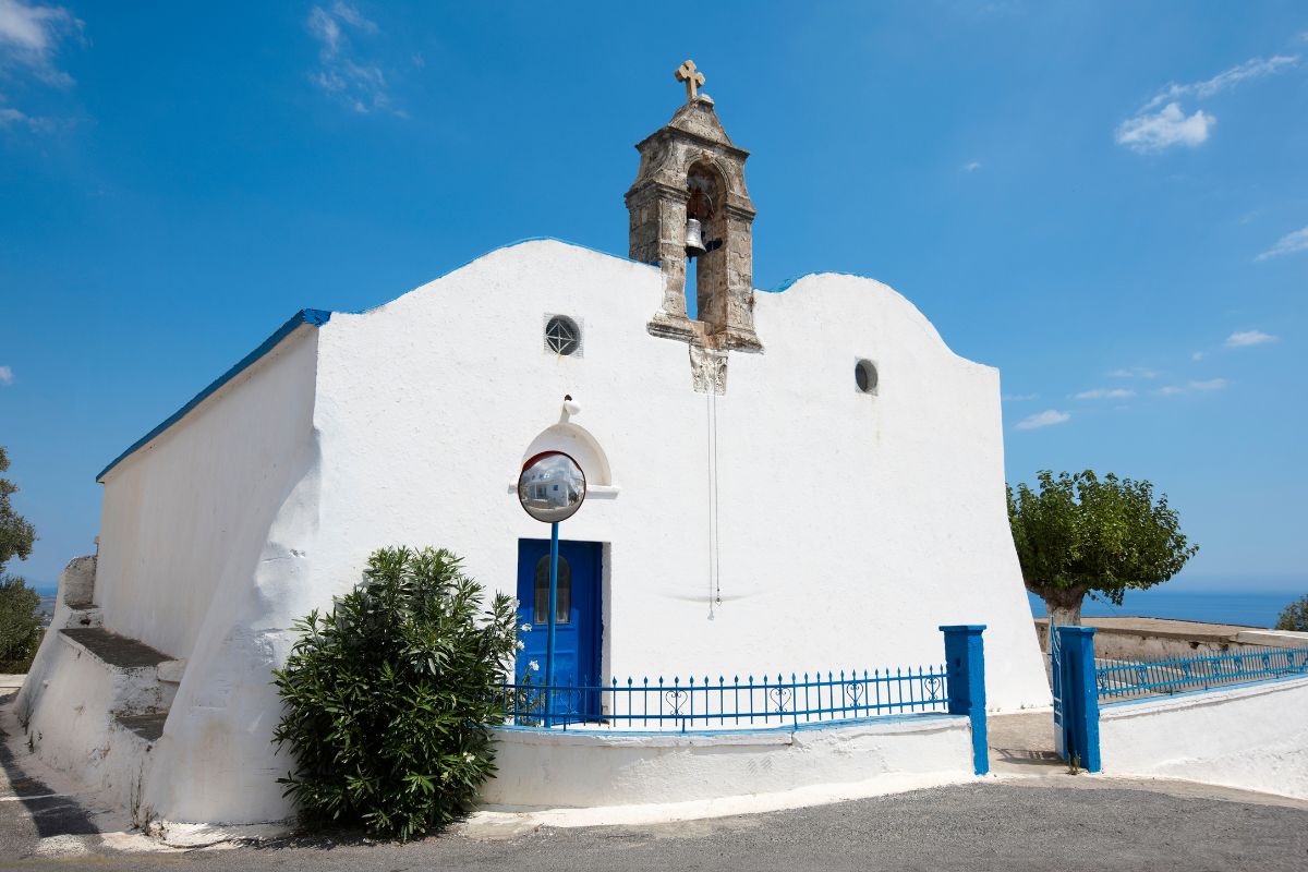 Whitewashed church with blue door in Komitades village near Imbros Gorge in Crete.