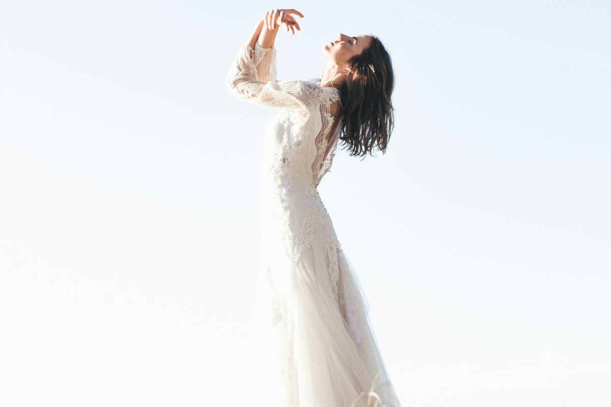 Woman in a flowing white dress symbolizing divine feminine healing, inner peace, and spiritual growth.