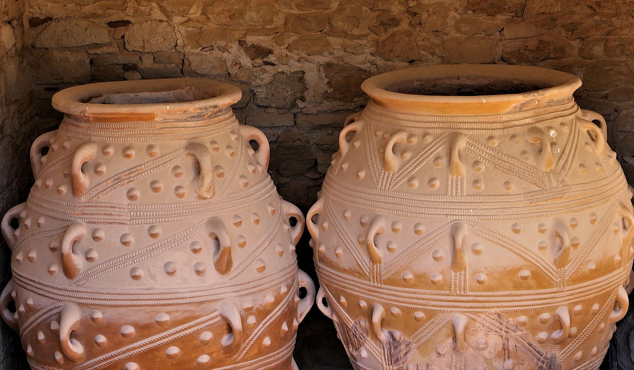 Large ancient pithoi storage jars displayed together in Crete