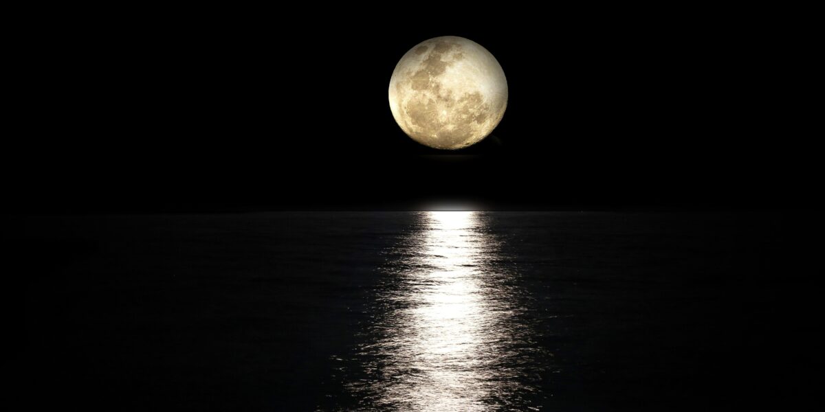 Bright August full moon glowing over the calm sea in Crete Greece