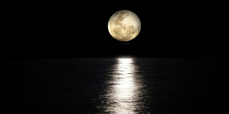 Bright August full moon glowing over the calm sea in Crete Greece