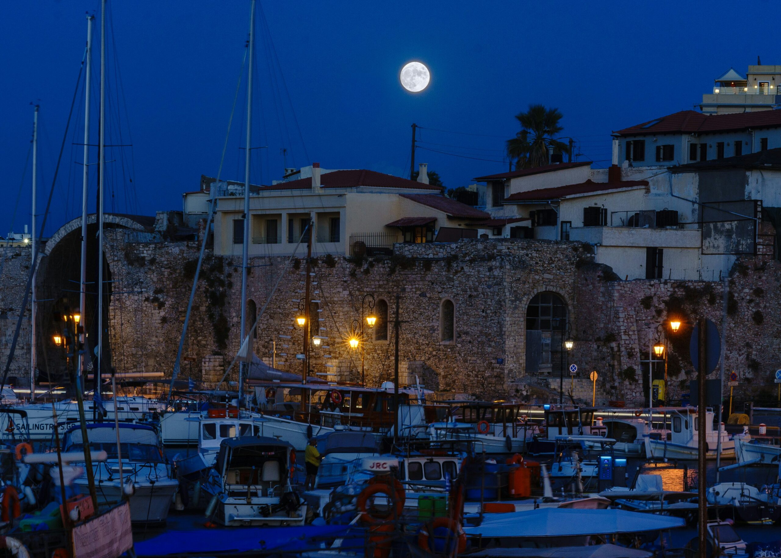August full moon rising over the Venetian harbor in Heraklion Crete