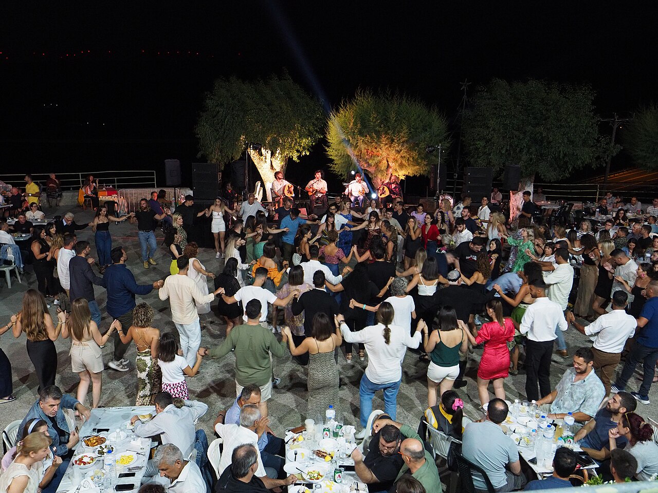 Traditional Cretan panigyri with people dancing at the Chamezi festival in Sitia, Crete