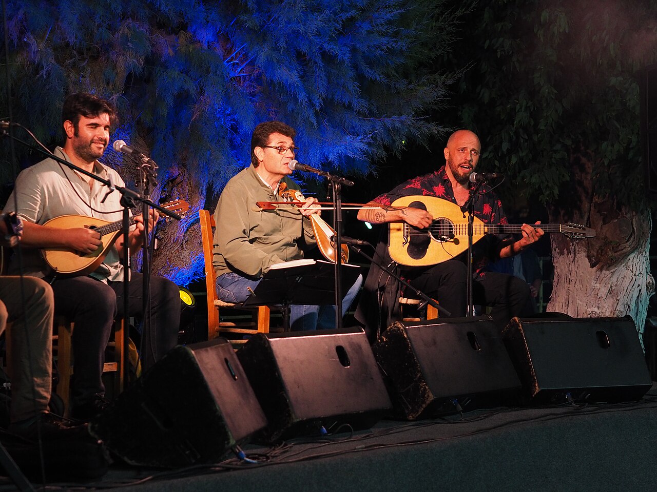 Traditional Cretan musicians playing lyra, laouto and mandolin at a village panigyri in Chamezi, Crete